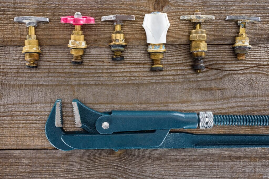 top-view-of-pipe-wrench-and-various-plumbing-valve-2023-11-27-05-29-00-utc_11zon