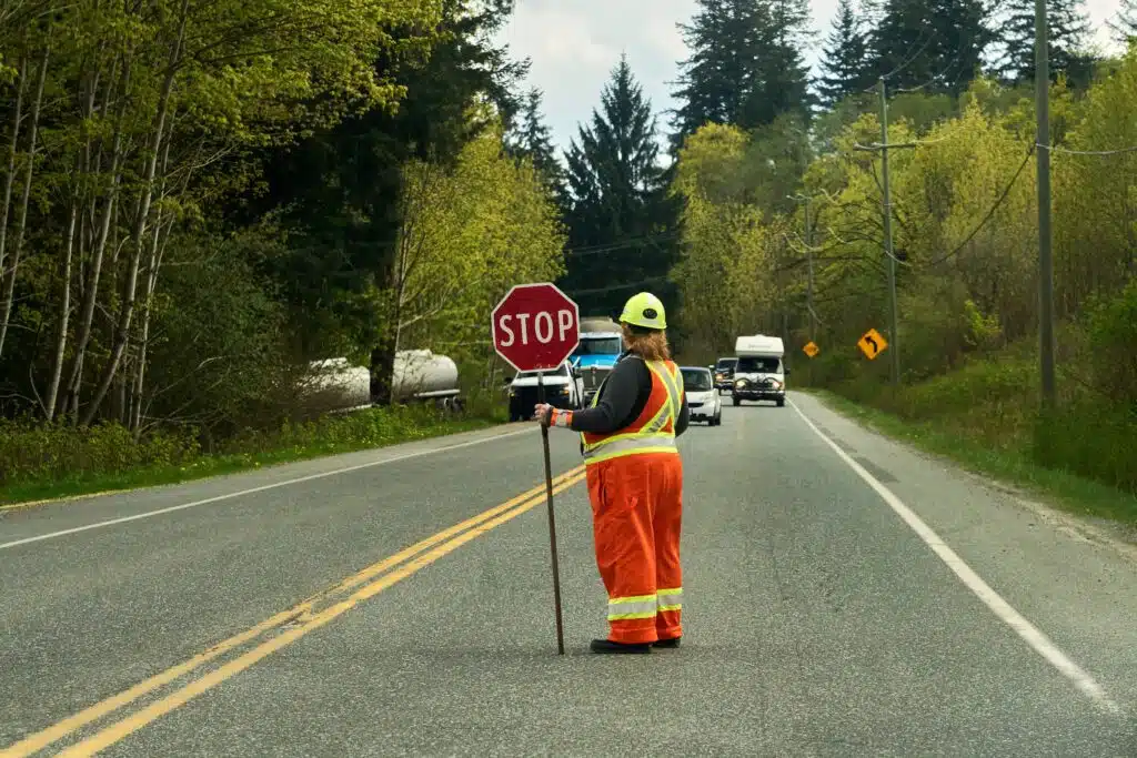 a-flag-person-stopping-traffic-for-emergency-crews-2024-04-26-20-15-03-utc_11zon