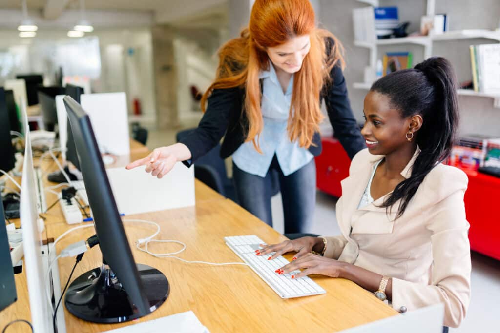 Business people collaborate in office and work on computer