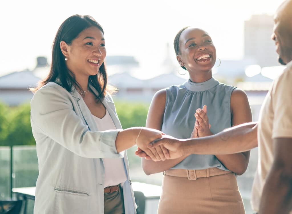 Business people, handshake and applause in collaboration, deal or agreement in city. Shaking hands,.