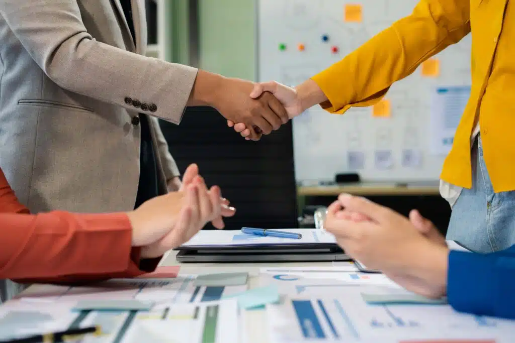 businesspeople-putting-hands-together-above-the-ta-2024-09-18-19-28-14-utc_11zon