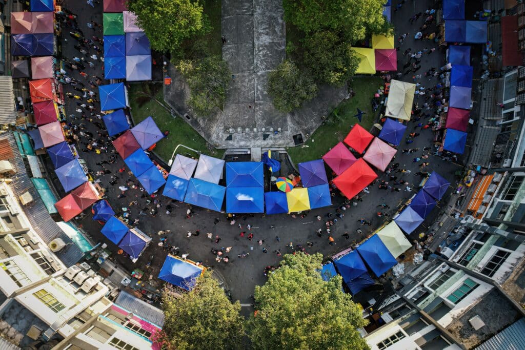 A circular cityscape depicting a large street with several tents in various colors in Malaysia