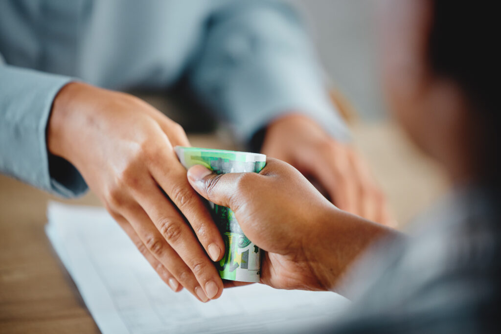 Closeup of hands, money exchange between businessman and customer for delivery or services done. Cu.