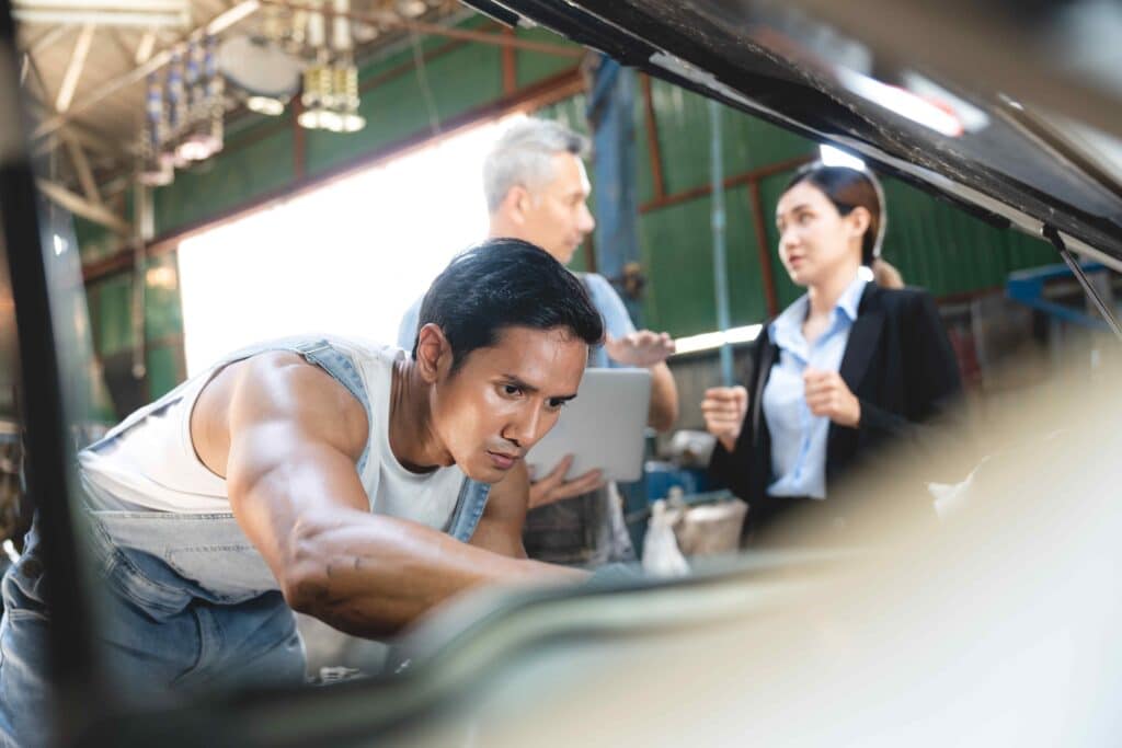 customer-talking-with-professional-mechanic-worker-2023-11-27-05-15-05-utc