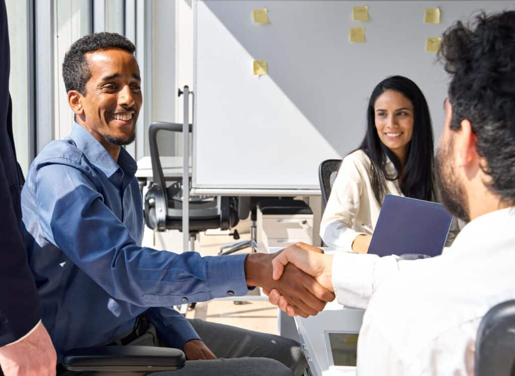 diverse-happy-business-men-handshaking-at-team-gro-2023-11-27-05-09-32-utc_11zon