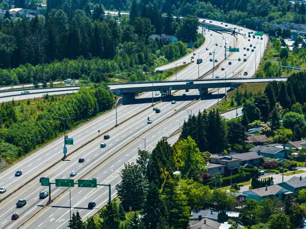 A drone shot of Coquitlam cityscape with Port Mann Bridge and greenery