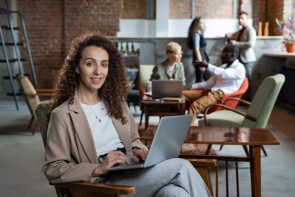 happy-young-businesswoman-with-laptop-sitting-in-a-2023-11-27-05-02-27-utc_11zon
