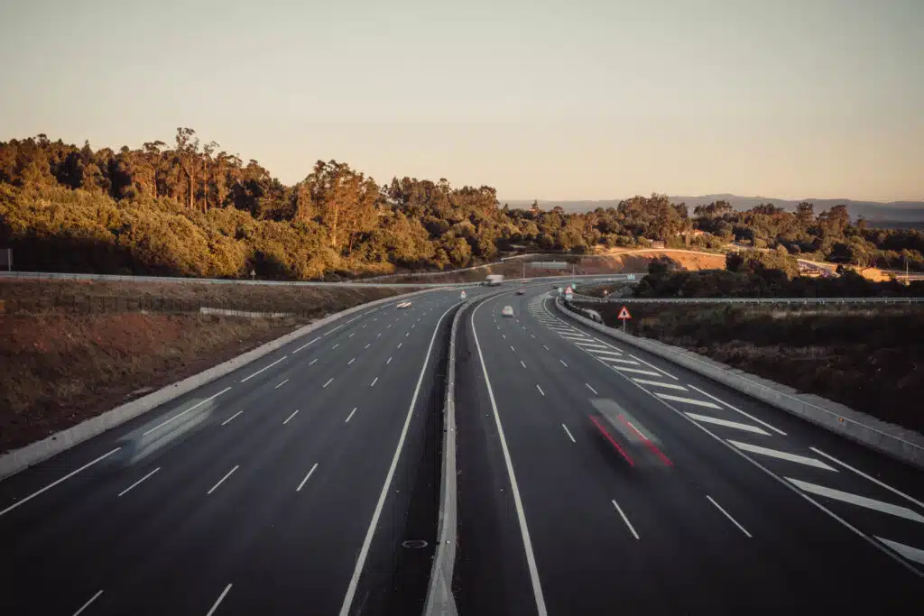 A long exposure shot of a highway with cars movement at sunset