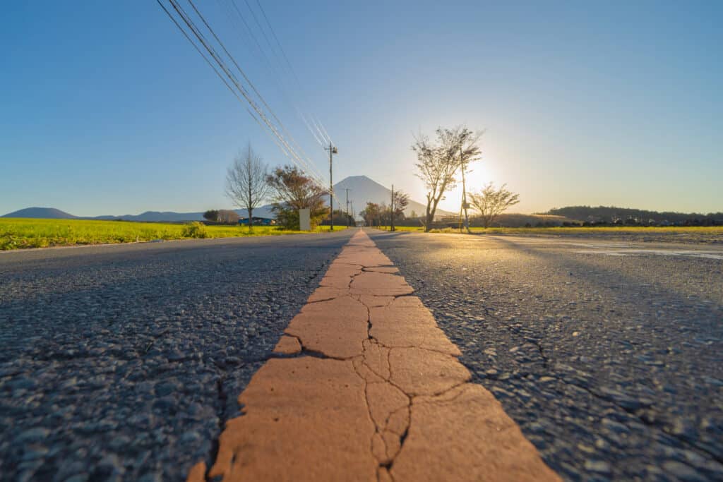 Mountain Fuji and street road with blue sky near Fuji Five Lakes, Fujikawaguchiko, Yamanashi, Japan. Nature landscape background.