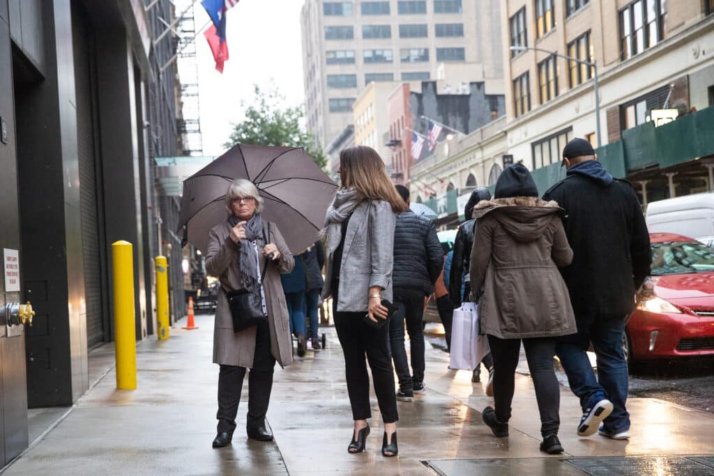 People outside on busy city sidewalk