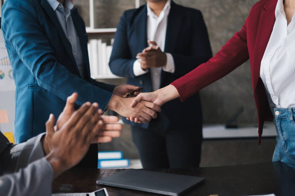 Professional businessman shaking client hand, closing successful deal.