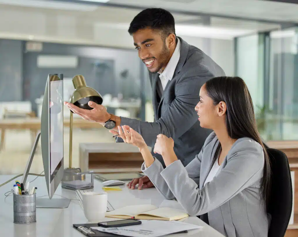 Shot of a young businessman and businesswoman using a computer in a modern office.