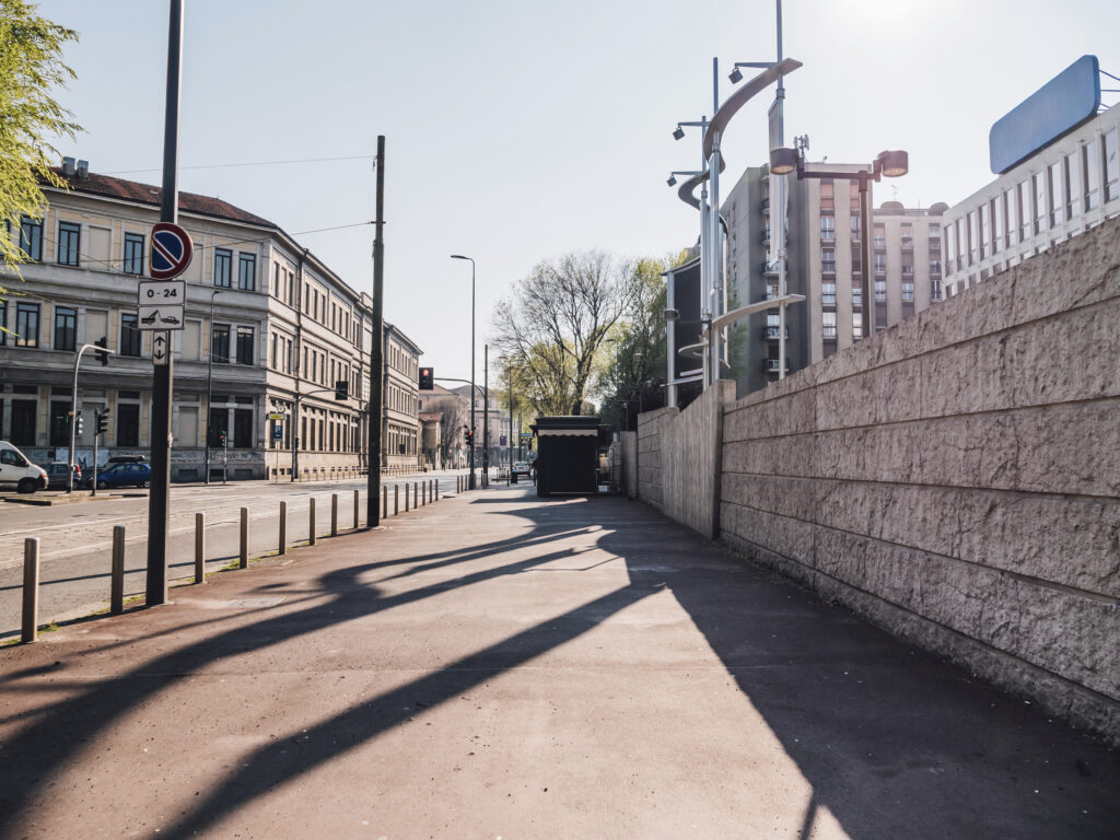 Sunny urban street corner with long shadows and no pedestrians
