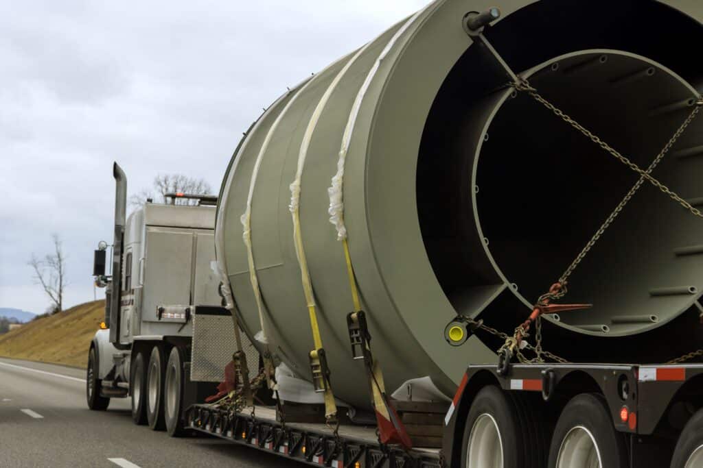 Heavy-duty trailer with a transportation of bulky goods on a traffic road