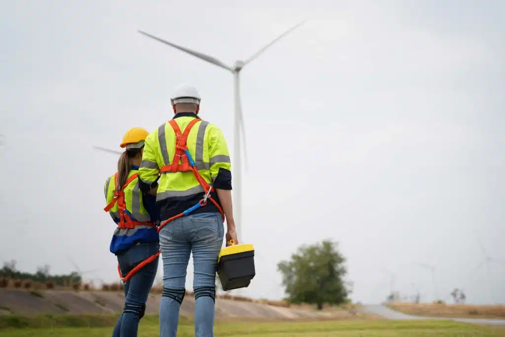 wide-perspective-of-wind-turbine-engineers-walking-2023-11-27-05-26-06-utc_11zon