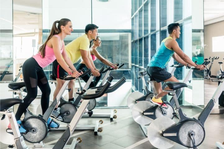 South Carolina Physical Fitness Center Special Deposit Bond - A physical fitness center. Group of people doing cycling for burning calories.