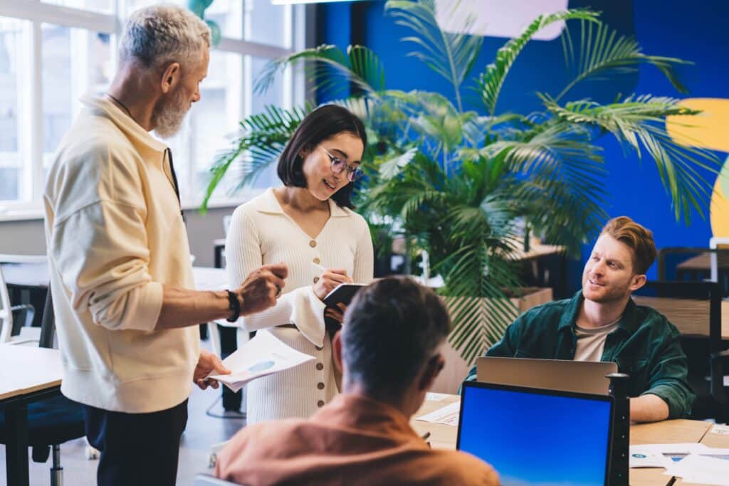 group-of-employees-with-technology-discussing-web-2024-05-02-21-18-48-utc_11zon