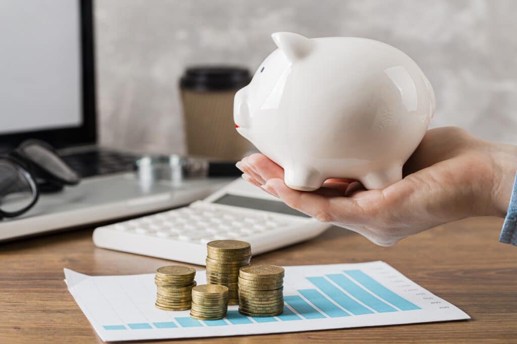 hand-holding-piggy-bank-with-growth-chart-coins