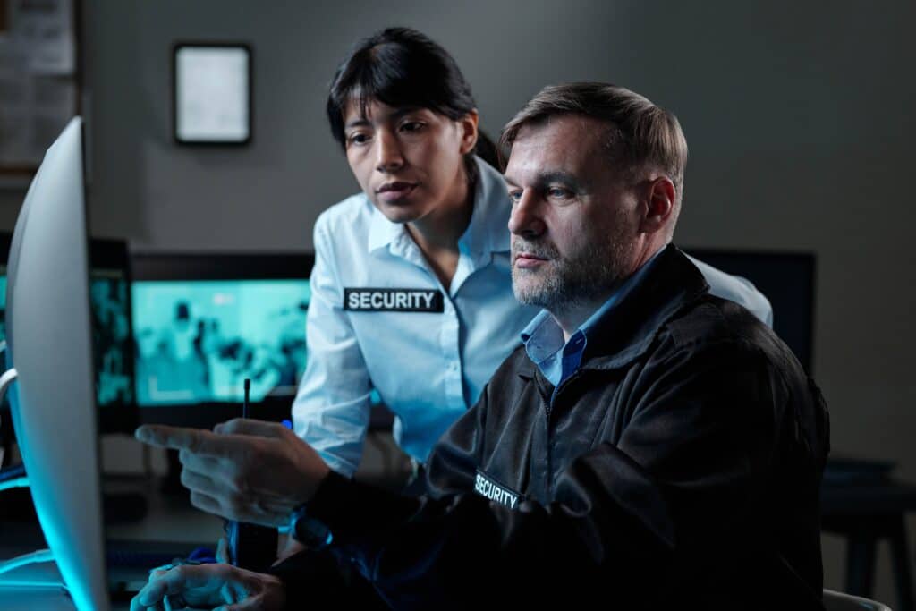 male-guard-pointing-at-computer-screen-2024-05-23-19-03-14-utc_11zon