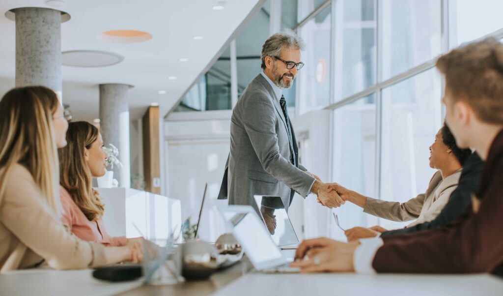 mature-businessman-explaining-strategy-to-group-of-2023-11-27-05-23-07-utc