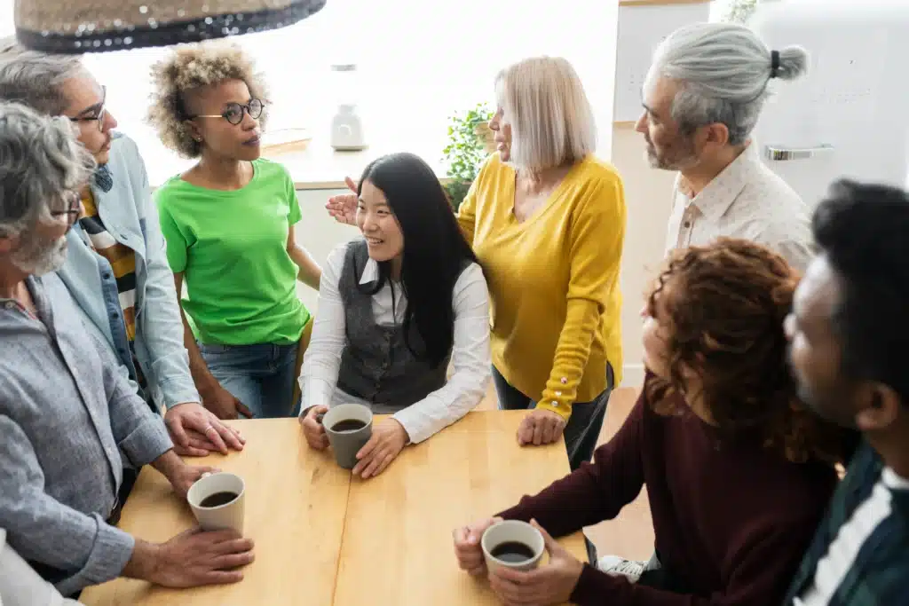 group-of-multiethnic-people-meeting-in-kitchen-wor-2023-11-27-05-29-30-utc