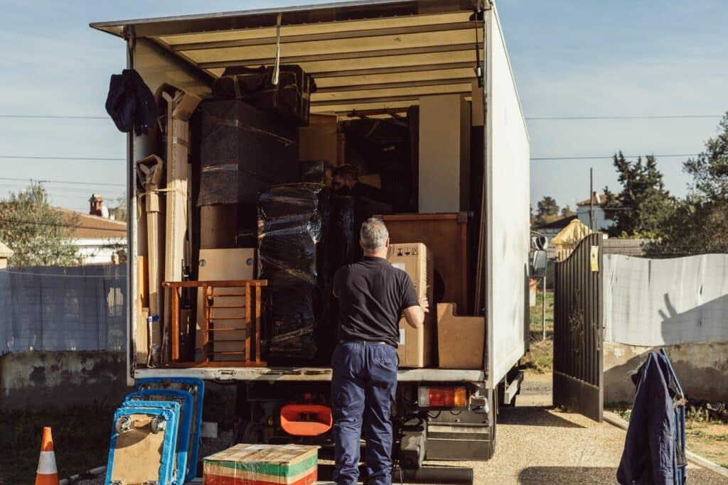 older-worker-loading-cardboard-boxes-onto-moving-t-2023-11-27-04-53-42-utc_11zon