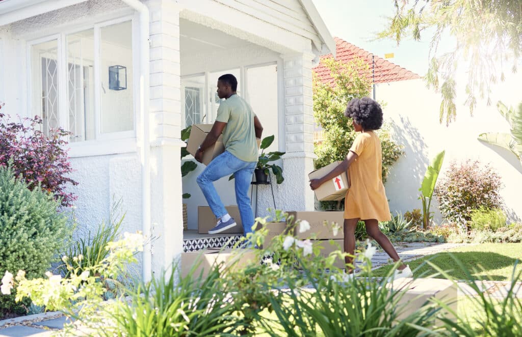Ready or not, here we come. Shot of a young couple moving into their new house
