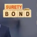 A man scratching his head and looking at wood blocks that have surety bonds, principal, obligee, surety and broker on each block.