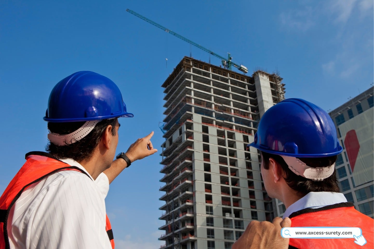 City building contractor looking at the constructed building.