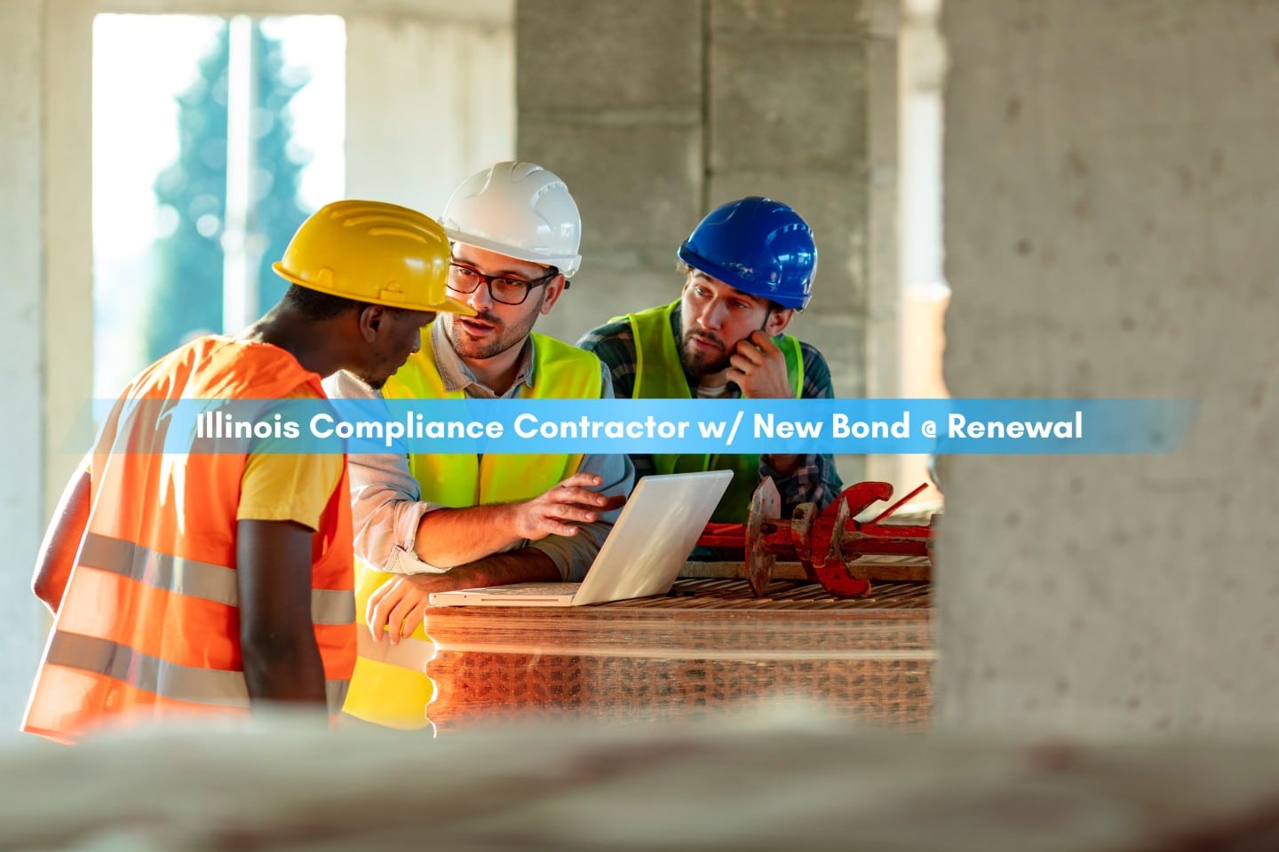 Illinois Compliance Contractor w/ New Bond @ Renewal - Construction workers using laptop on construction site wearing their uniform and hard hat.