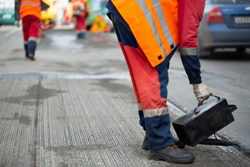 a-worker-pours-liquid-asphalt-molten-bitumen-from-2024-08-08-08-02-52-utc_11zon