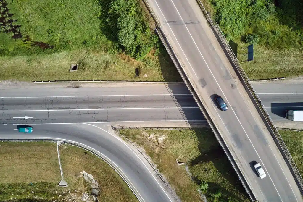 aerial-view-of-road-intersection-with-fast-moving-2023-11-27-04-50-20-utc_11zon