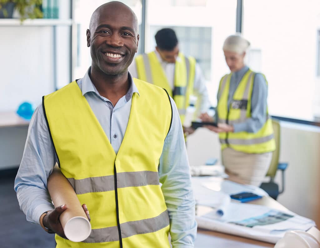 Black man, architect and portrait smile with blueprint for building or construction plan at the off.