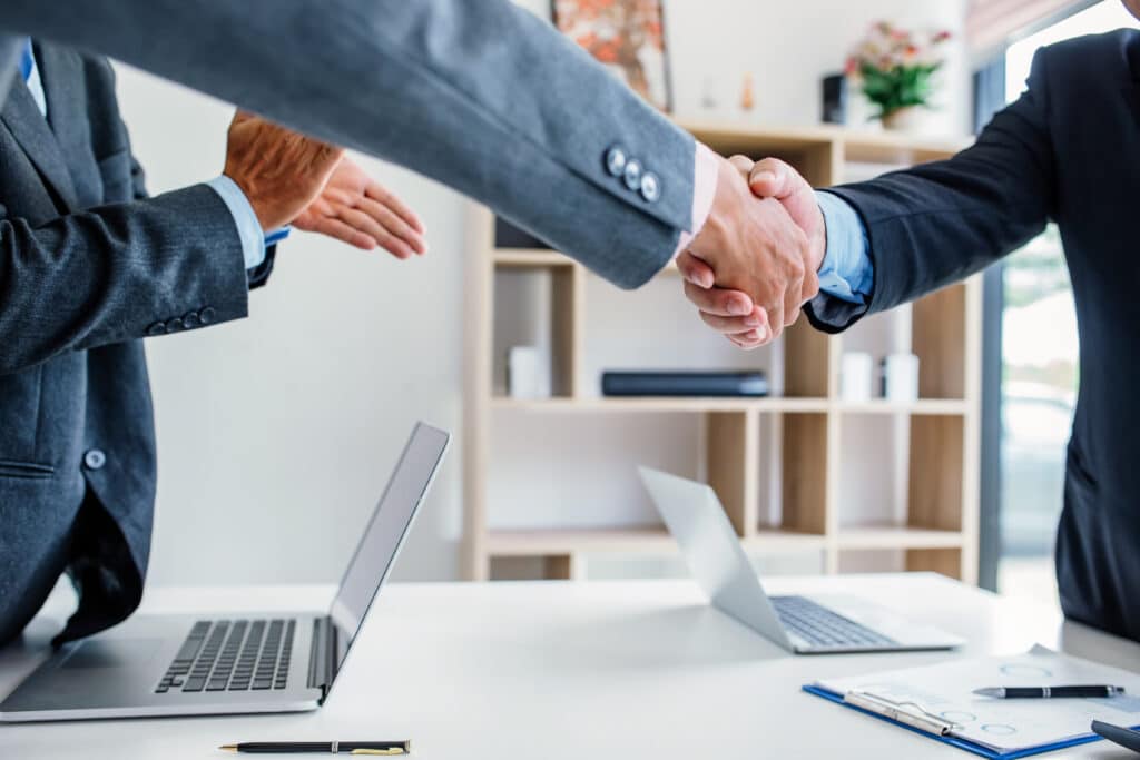 Businessman handshake at the meeting and congratulated on the success of their business.