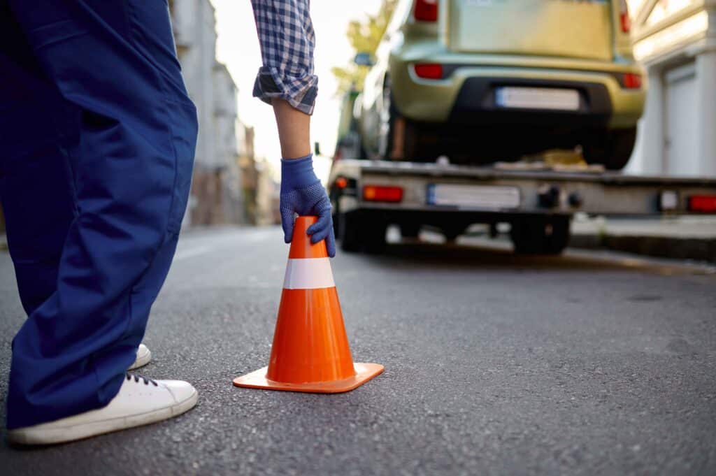 road-worker-putting-traffic-cone-on-roadside-2023-11-27-05-05-22-utc_11zon