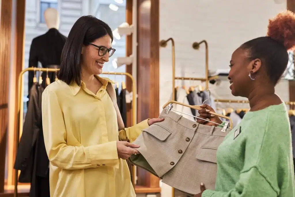 smiling-woman-looking-at-clothes-in-boutique-with-2023-11-27-05-22-11-utc_11zon