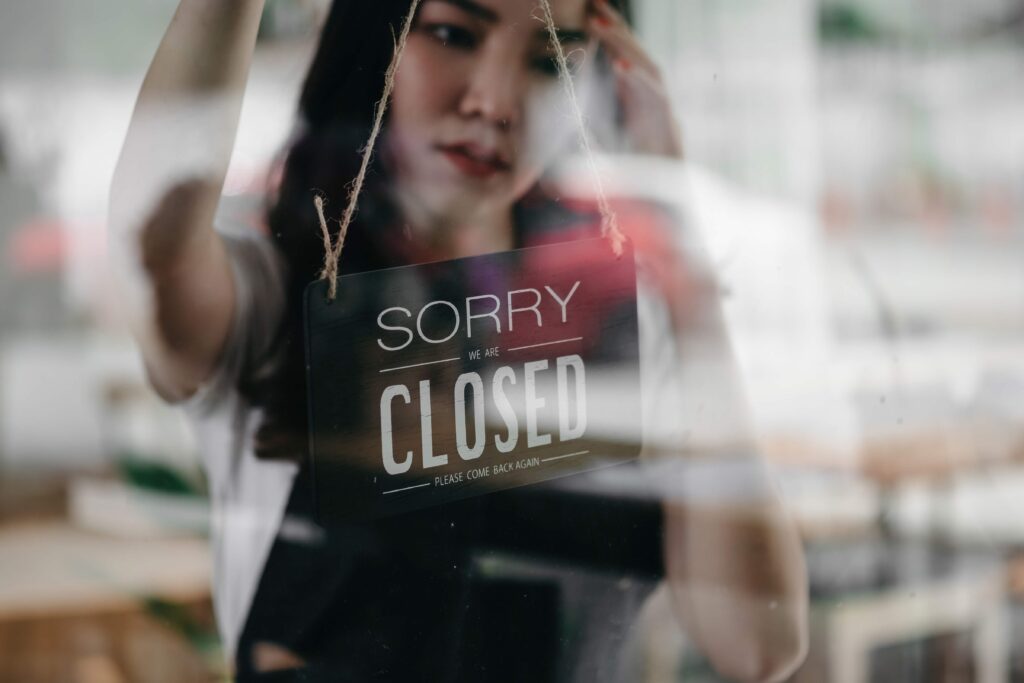 woman-entrepreneur-hand-turning-close-sign-board-o-2023-11-27-05-28-28-utc_11zon