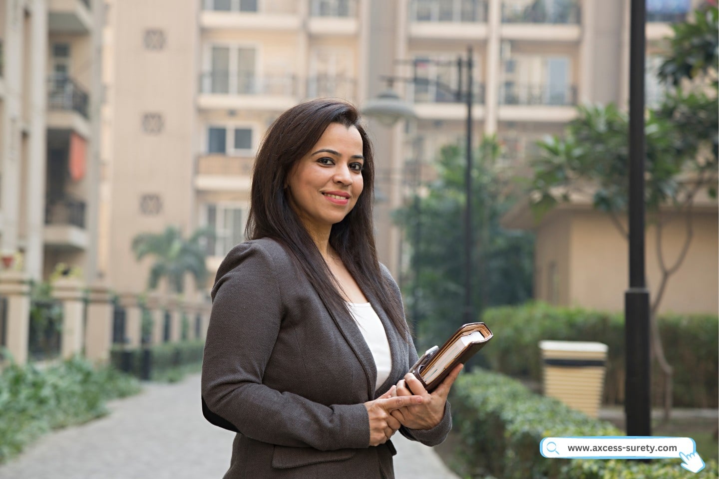 A collection agent holding her records while standing at the residential place.