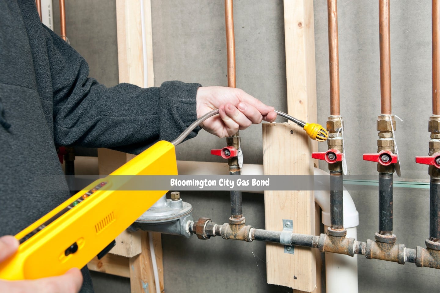 Bloomington City Gas Bond - A worker near residential gas pipes is using a leak detector.