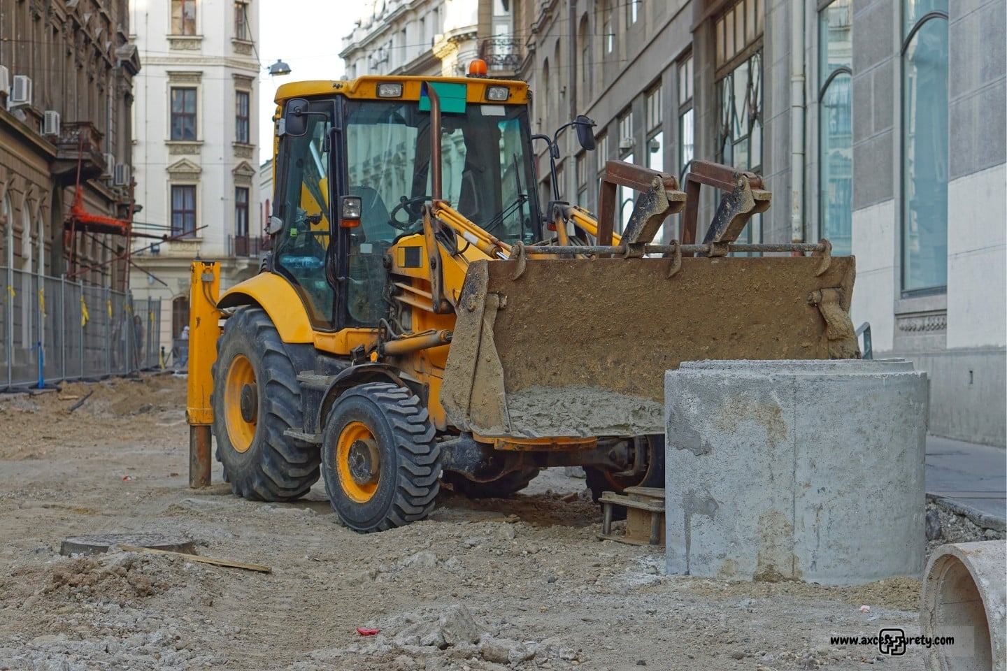 Backhoe digger loader machine at the city sewer construction site.