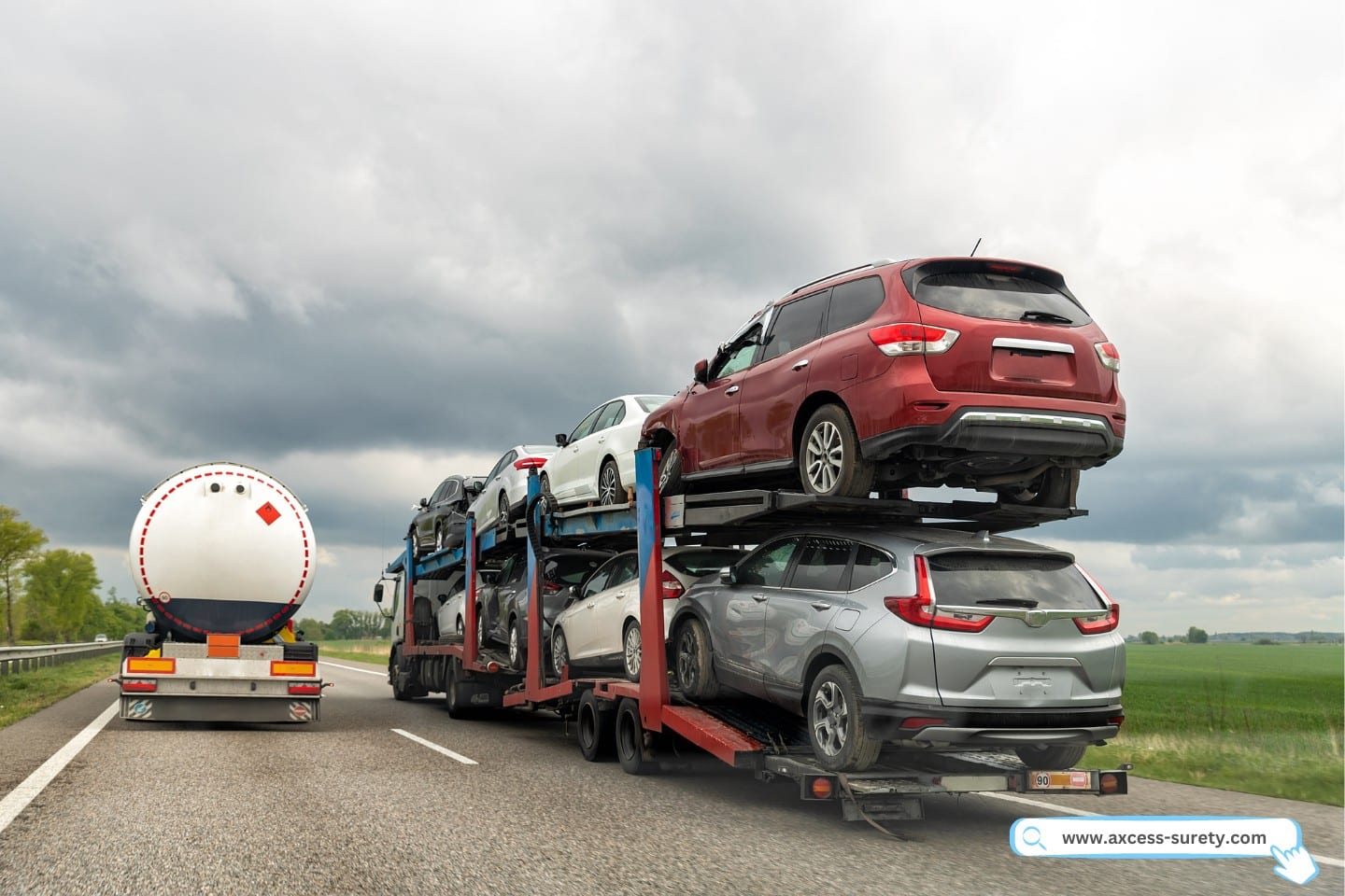 A group of damaged cars were being carried by a tow truck car carrier on the highway.