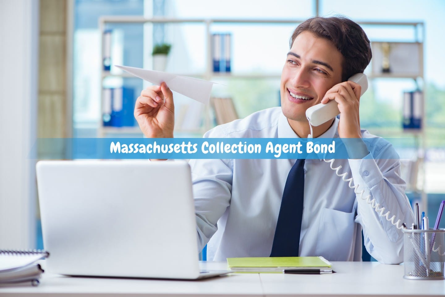 Massachusetts Collection Agent Bond - Agent playing with a paper airplane on his table and taking a call.