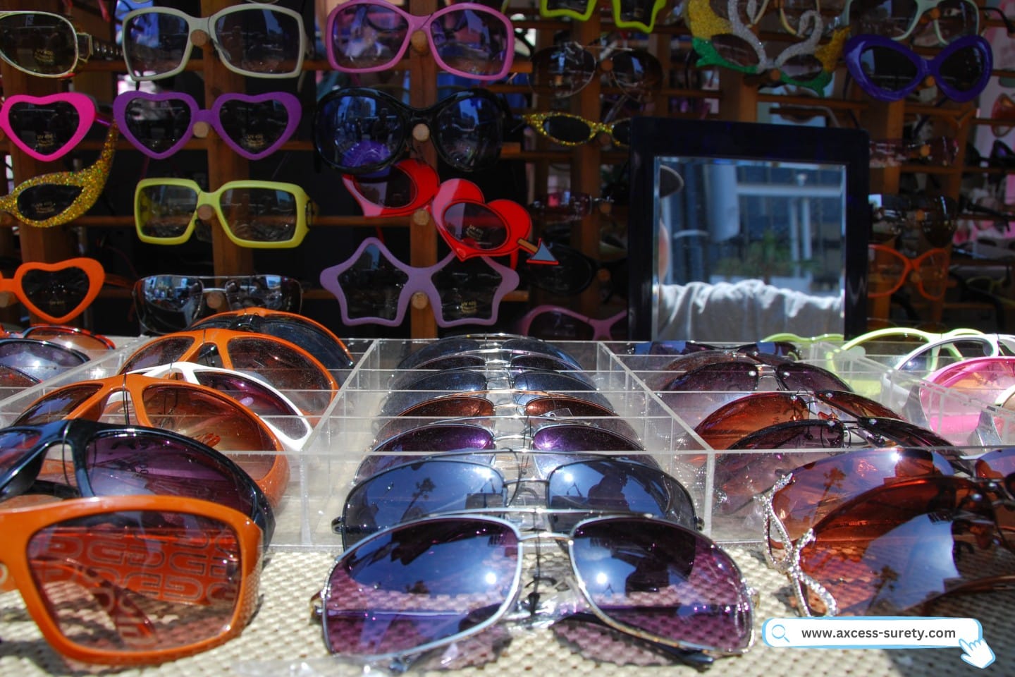 Sunglasses for sale on a table full.