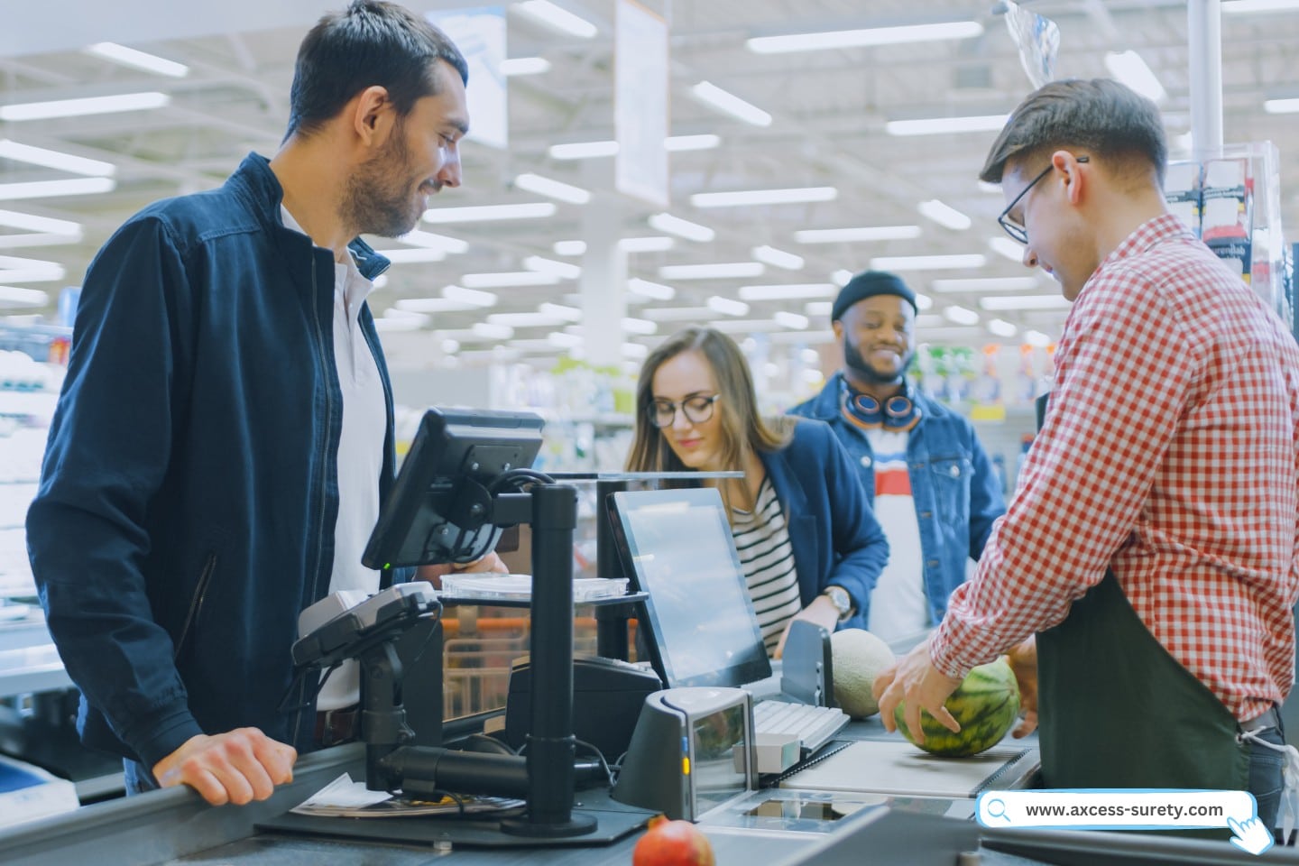 in the grocery store. The skilled cashier at the checkout desk scans food and grocery products.