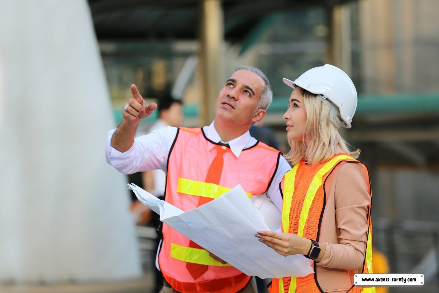 A businessperson and an engineer are on the construction site.