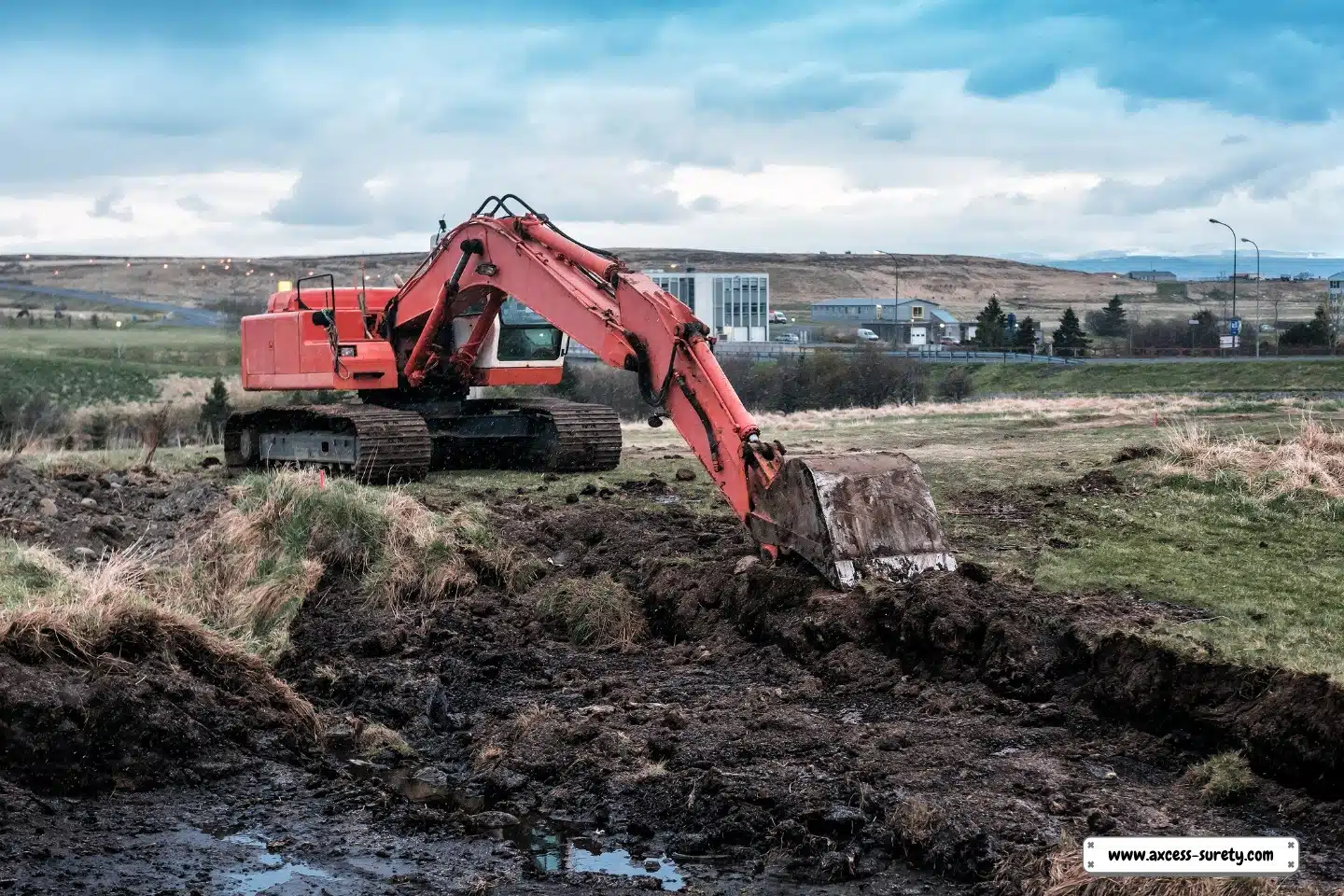 An isolated location with a red excavator working the soil.