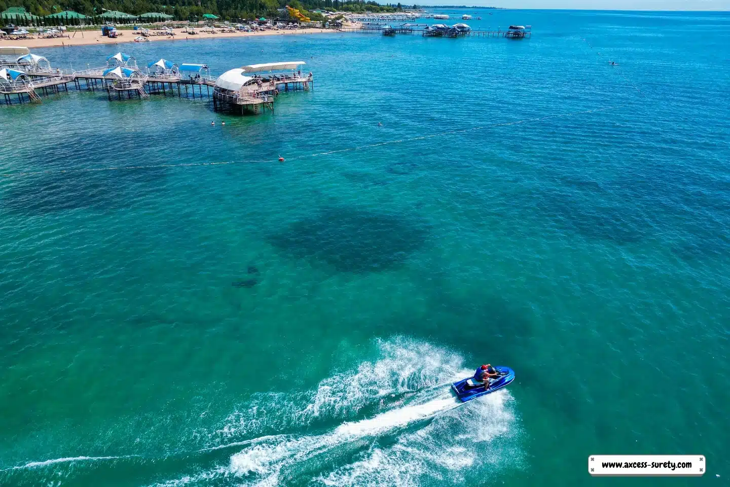 Aerial image of a man in the sea on his own boat.