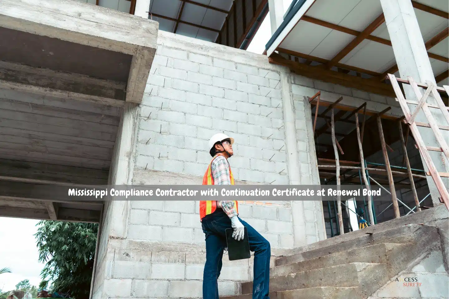 Mississippi Compliance Contractor with Continuation Certificate at Renewal Bond - A construction worker checks that the building construction requirements are being followed while carrying a digital tablet.