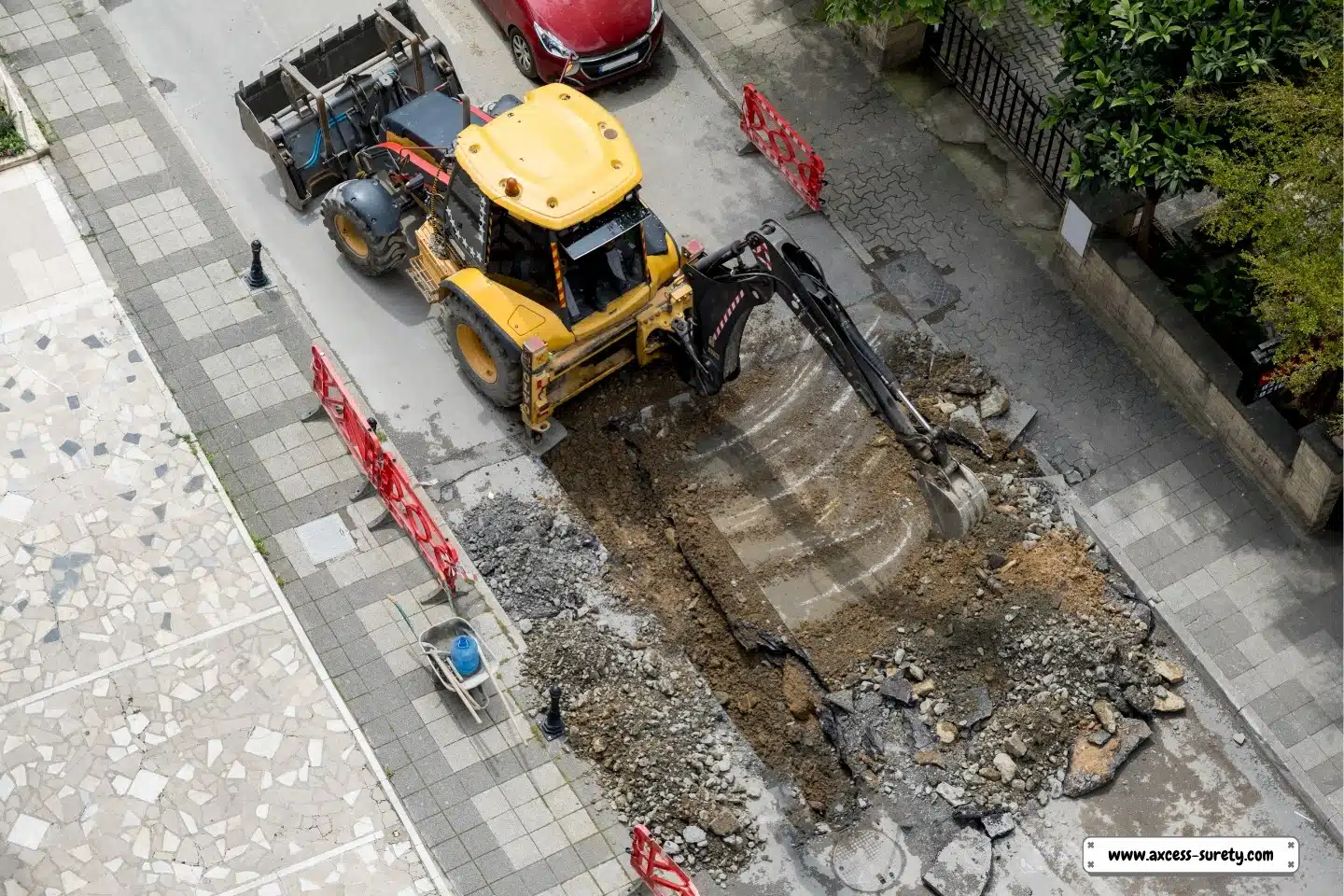 On a summer day, an excavator fixes sewage storm drains at a roadway.