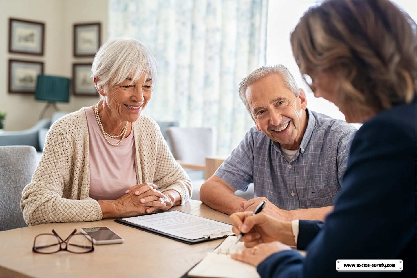 A financial agent consults with an elderly couple.